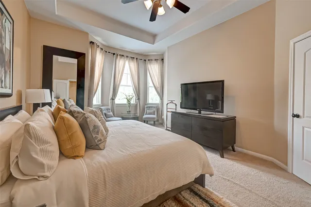 a bedroom with a bed and a painting on the wall