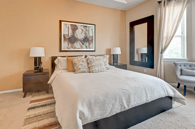 a bedroom with bed and a chandelier