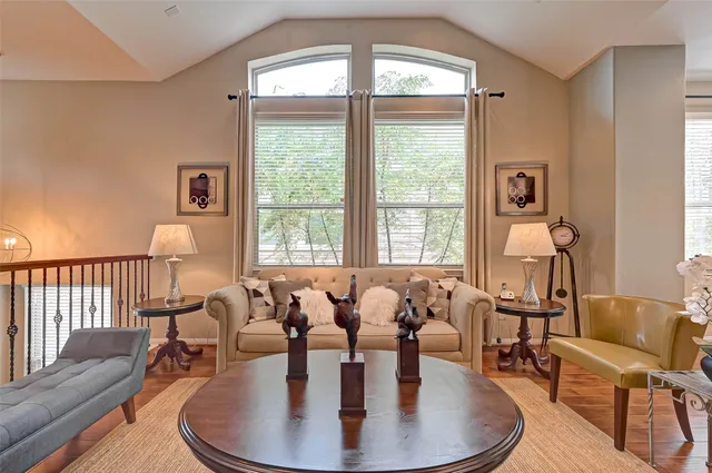 a dining room with furniture a chandelier and wooden floor