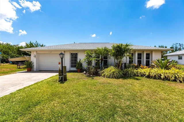 a view of a house with backyard and sitting area