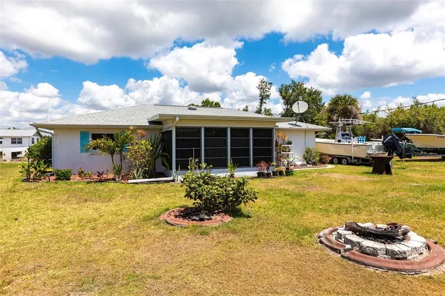 a view of a house with swimming pool and sitting area