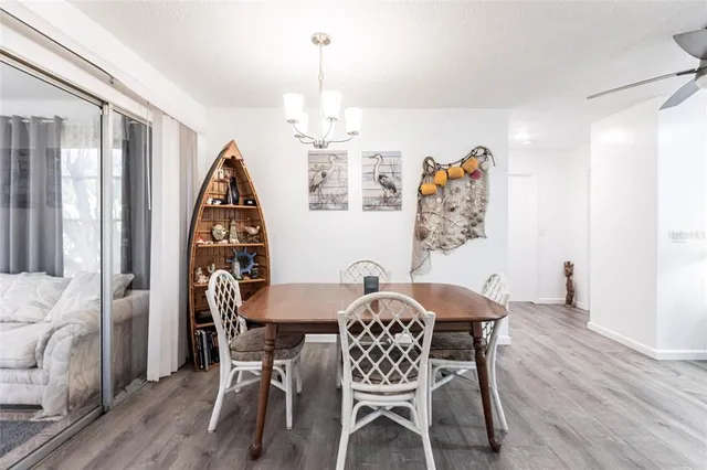 a view of a dining room with furniture wooden floor and a chandelier