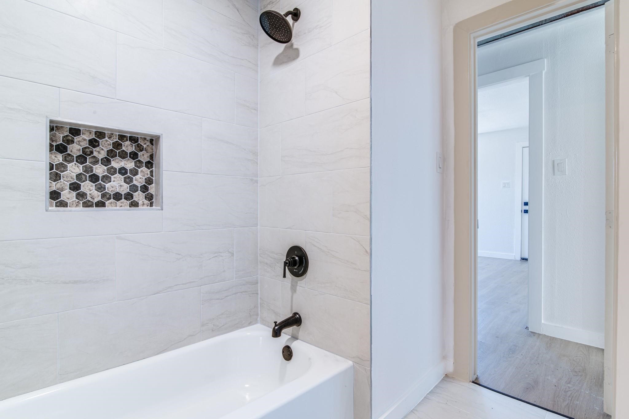 1105 North Valderas Street Angleton, TX 77515 - Photo 12 of 17 a bathroom with a bathtub and shower