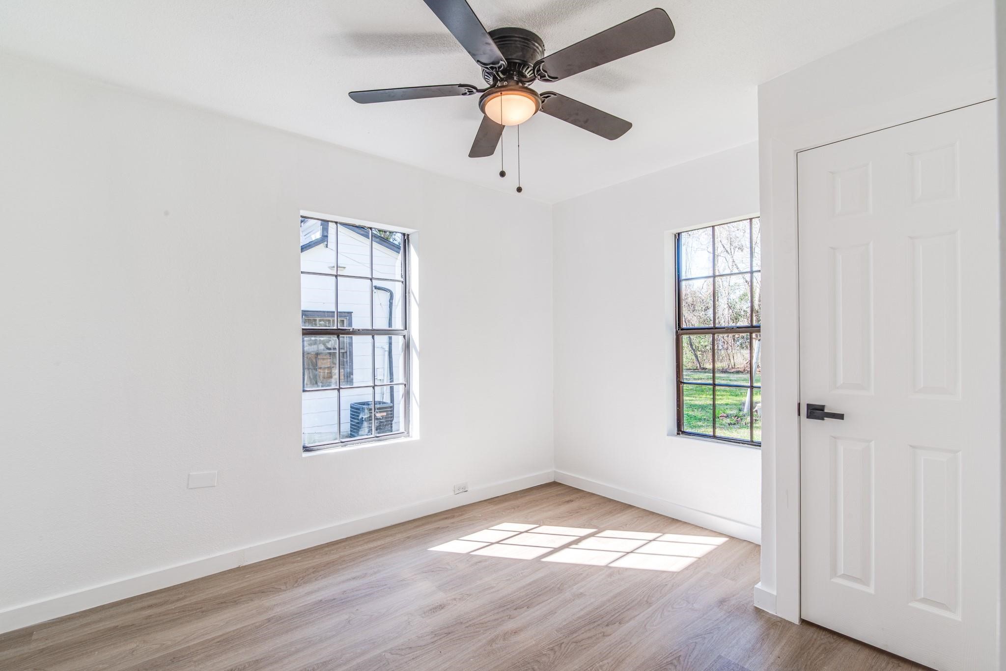 1105 North Valderas Street Angleton, TX 77515 - Photo 13 of 17 wooden floor in an empty room with a window