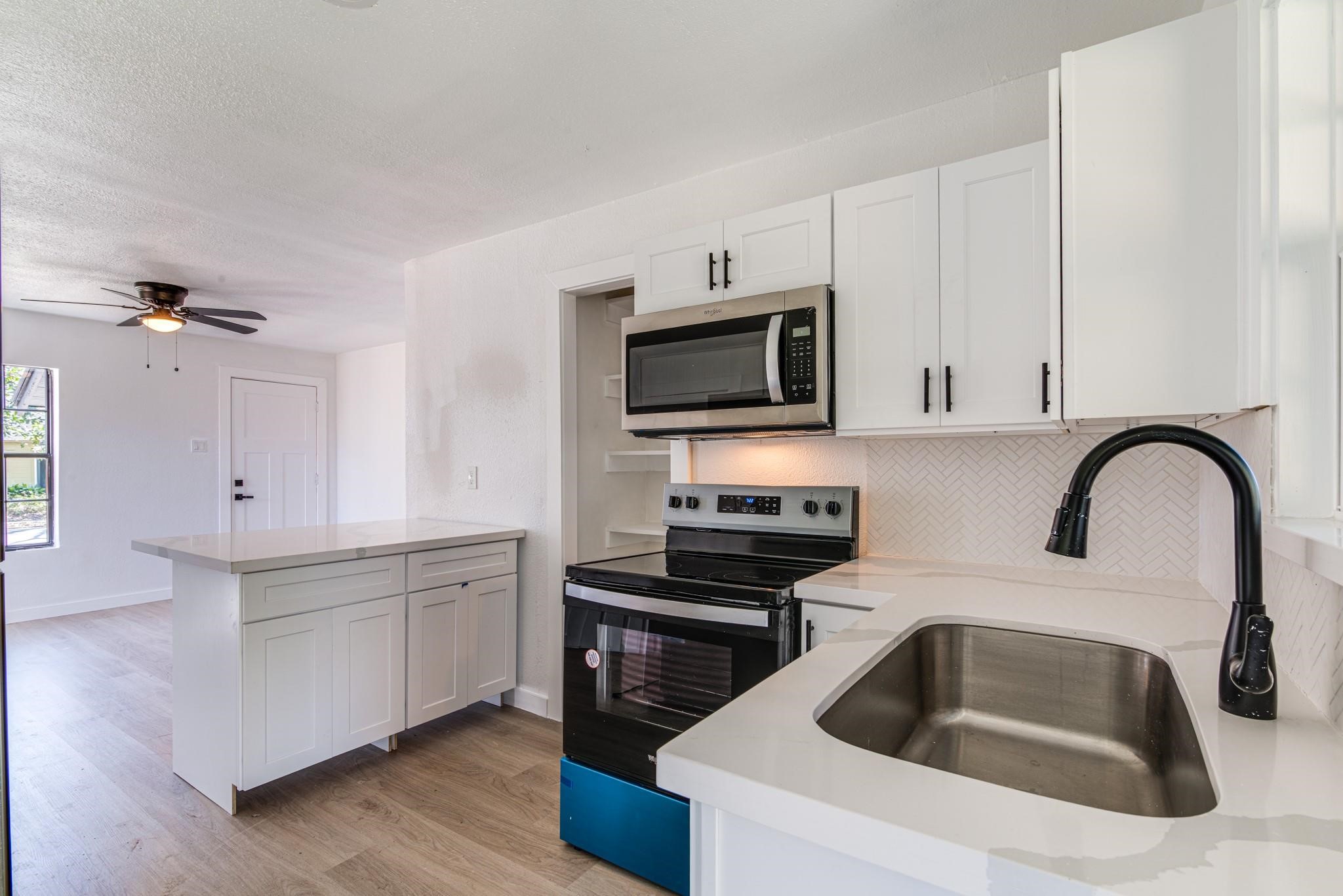 1105 North Valderas Street Angleton, TX 77515 - Photo 2 of 17 a kitchen with a sink cabinets and appliances