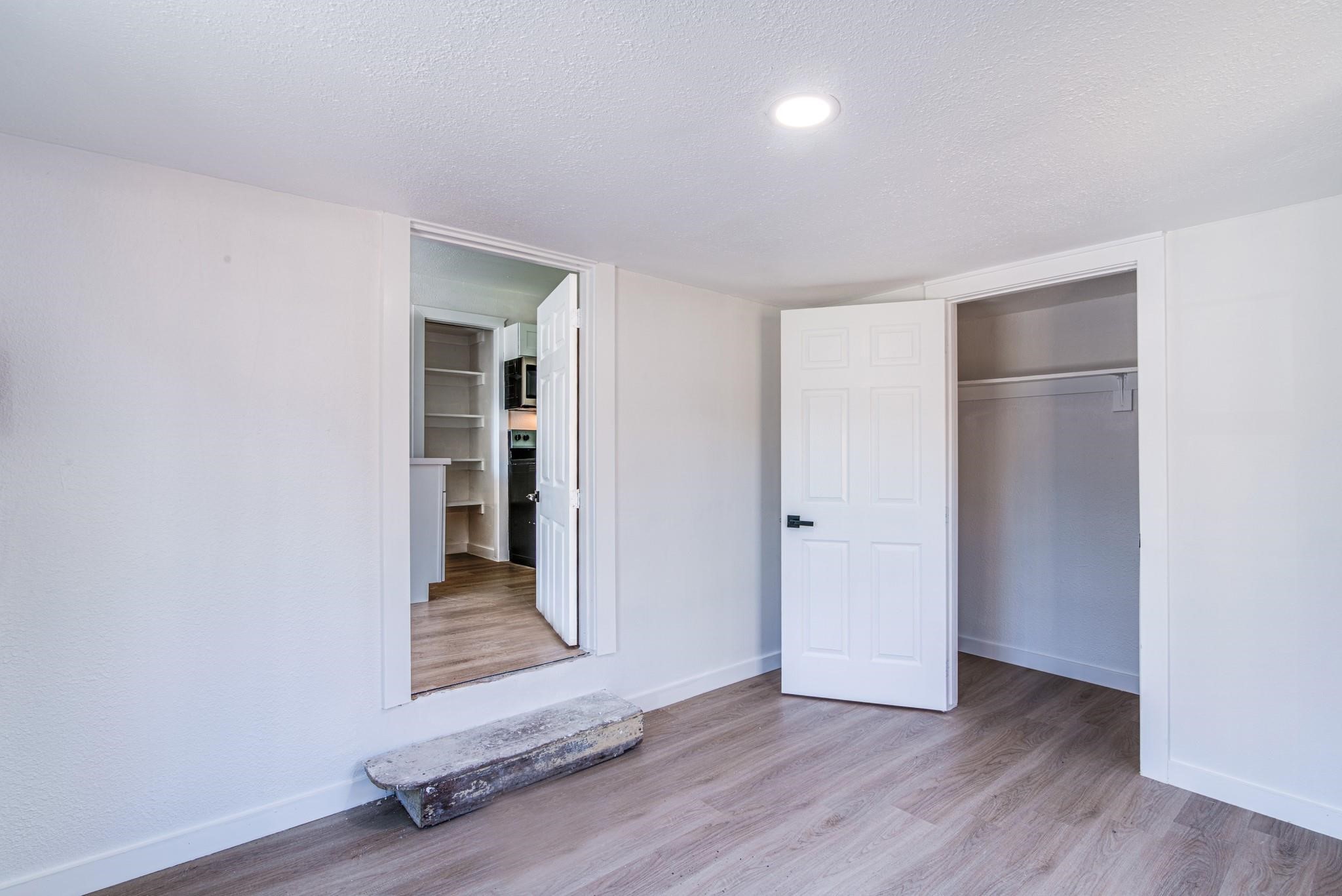 1105 North Valderas Street Angleton, TX 77515 - Photo 6 of 17 an empty room with wooden floor and closet