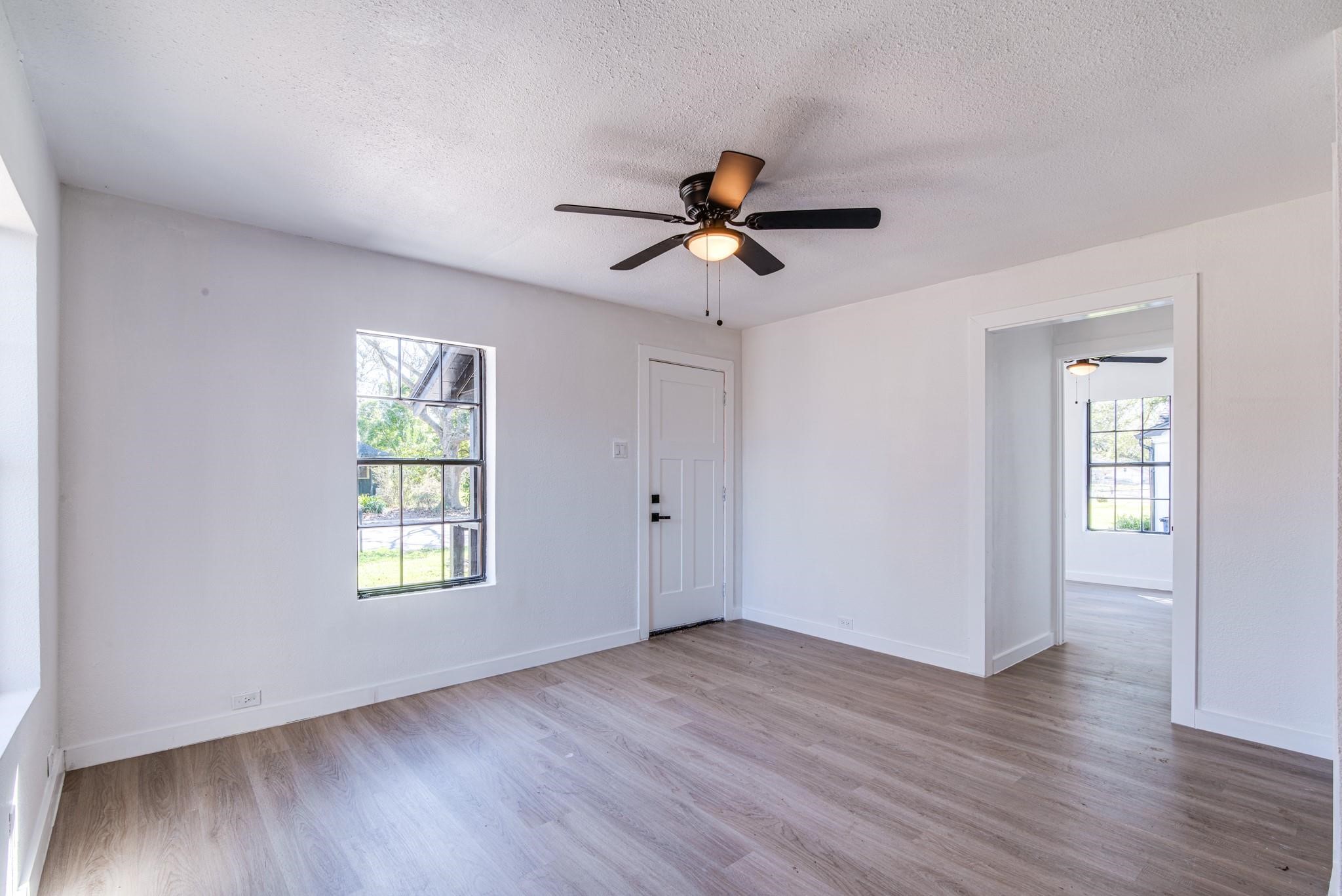1105 North Valderas Street Angleton, TX 77515 - Photo 7 of 17 a view of empty room with wooden floor and fan