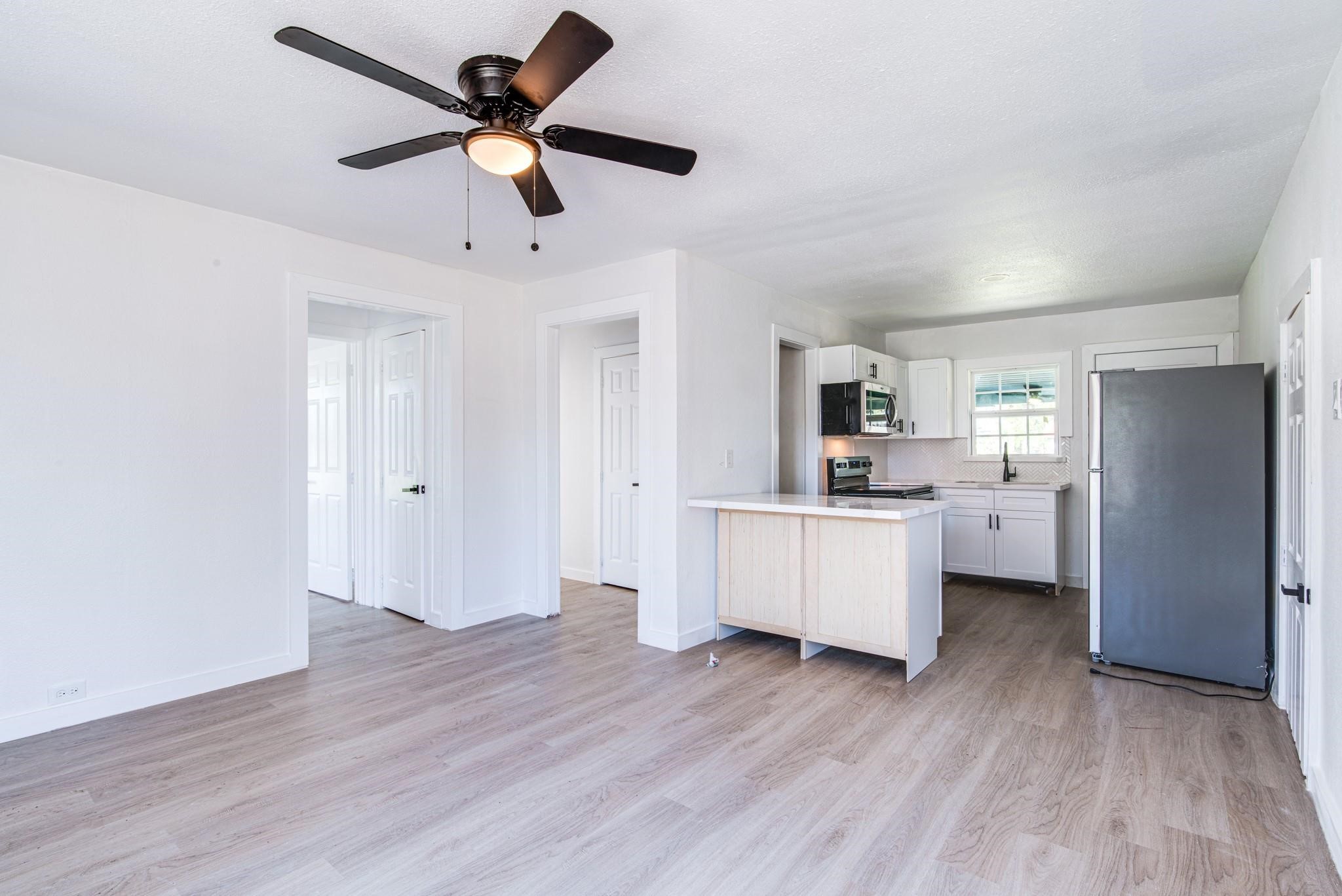 1105 North Valderas Street Angleton, TX 77515 - Photo 8 of 17 a living room with furniture and a kitchen