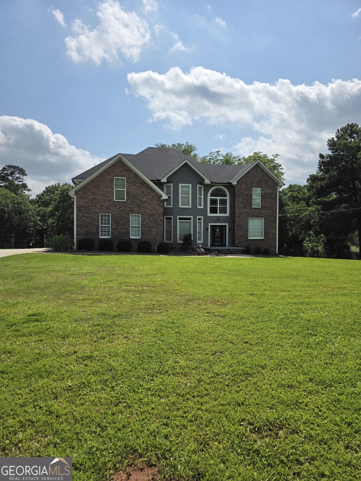 892 Perimeter Road Monticello, GA 31064 - Photo 2 of 38 a view of a house with a big yard and large trees