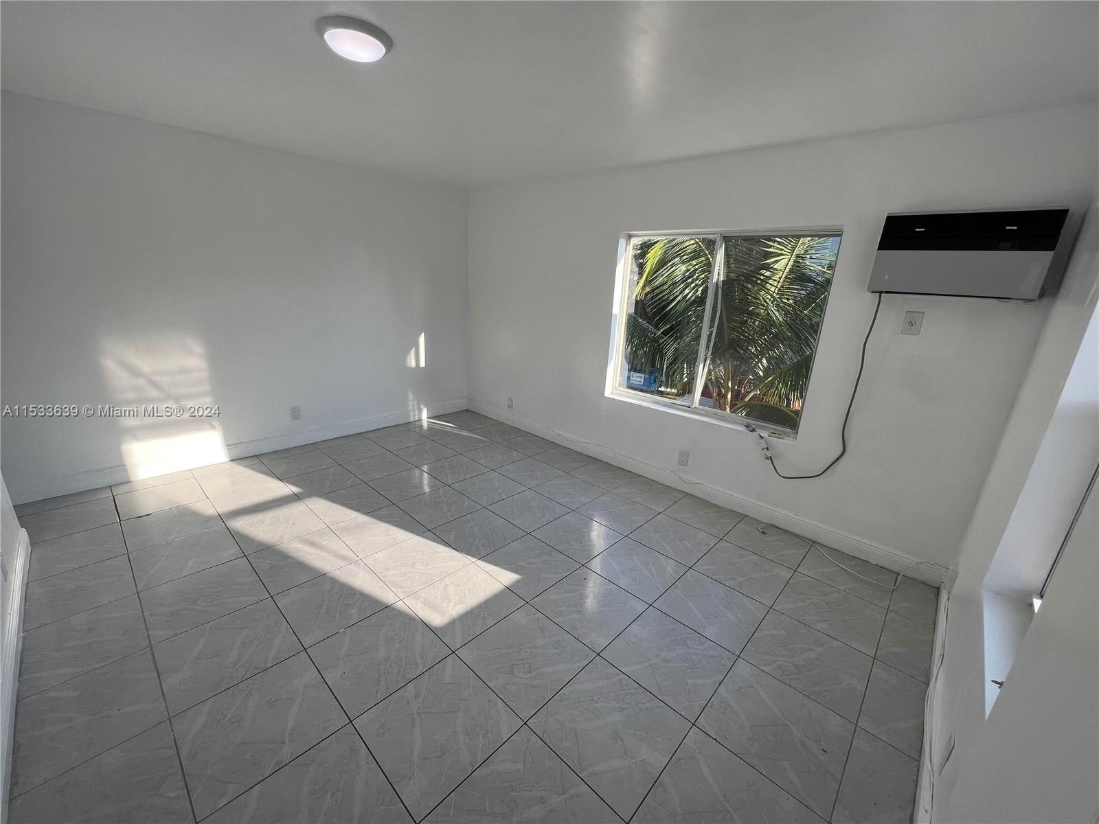 1935 Southwest 2nd Street, Unit 2 Miami, FL 33135 - Photo 1 of 12 a view of an empty room with a window
