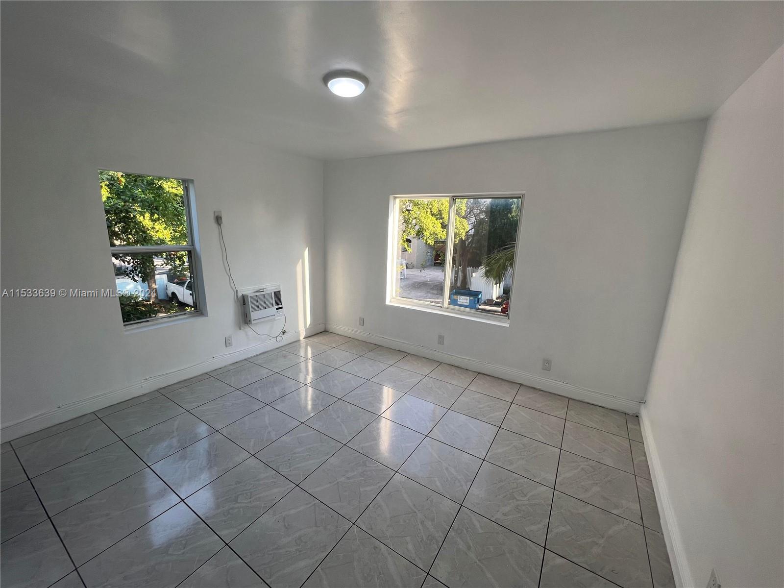 1935 Southwest 2nd Street, Unit 2 Miami, FL 33135 - Photo 7 of 12 an empty room with windows and closet