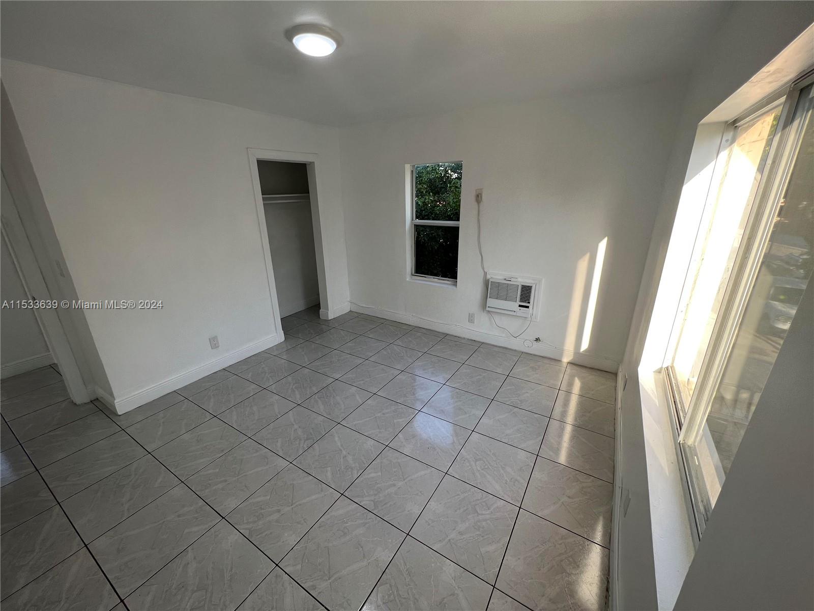 1935 Southwest 2nd Street, Unit 2 Miami, FL 33135 - Photo 8 of 12 an empty room with windows