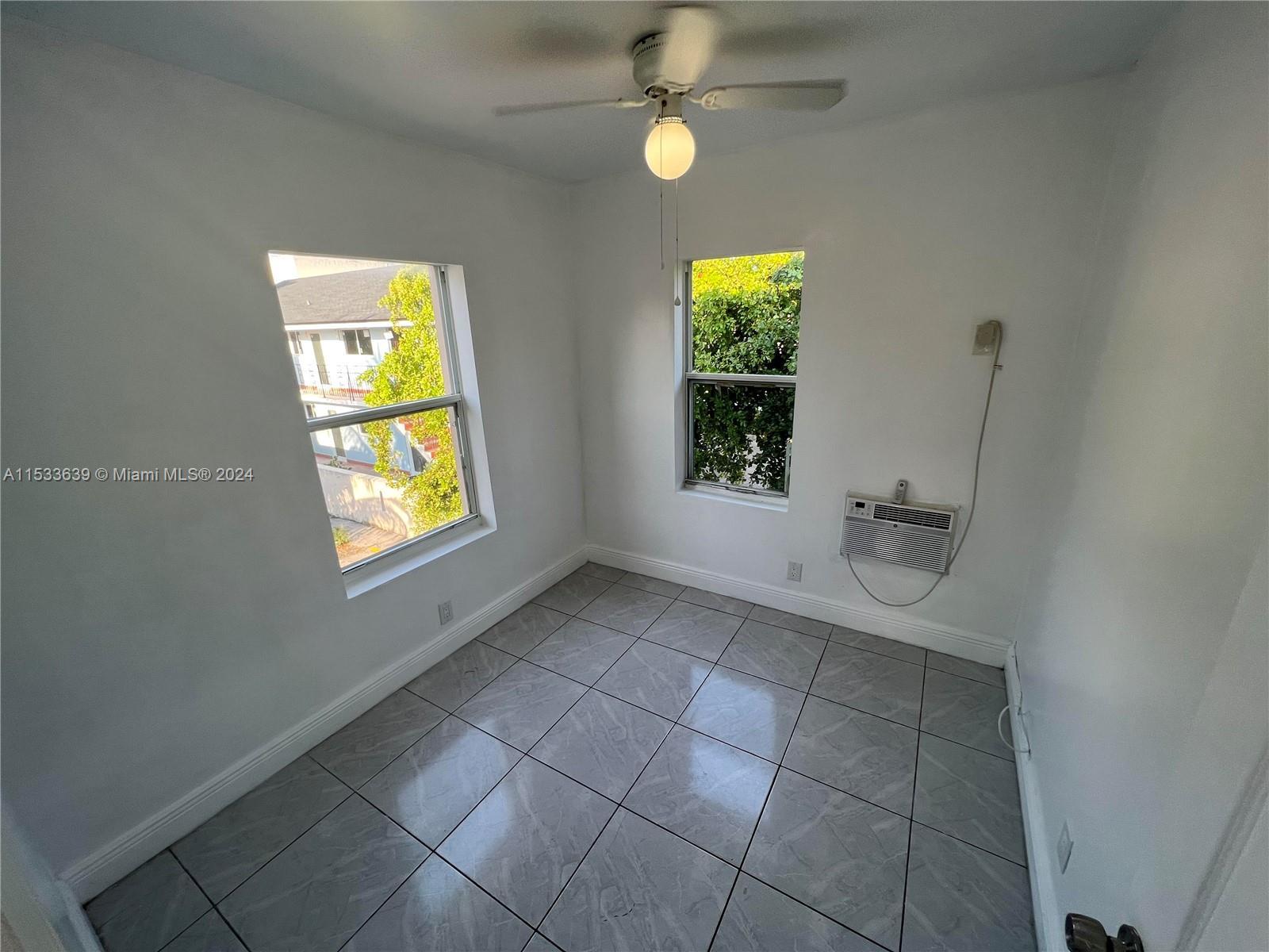 1935 Southwest 2nd Street, Unit 2 Miami, FL 33135 - Photo 9 of 12 an empty room with windows and closet