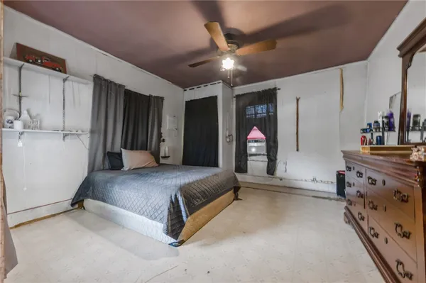a spacious bedroom with a bed and a view of walk in closet