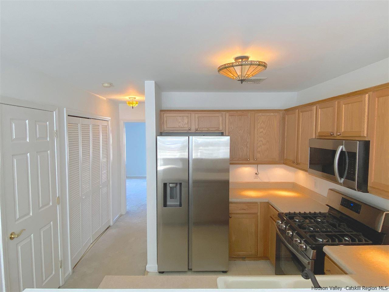 1036 Maggie Road, Unit 148 Newburgh, NY 12550 - Photo 12 of 19 a kitchen with stainless steel appliances granite countertop a refrigerator and a sink
