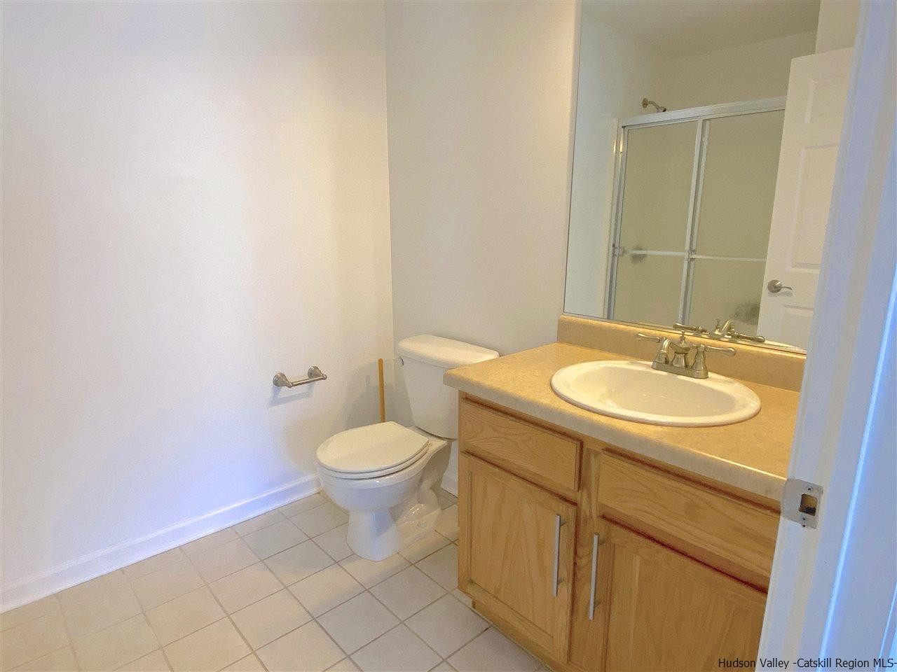 1036 Maggie Road, Unit 148 Newburgh, NY 12550 - Photo 15 of 19 a bathroom with a sink a toilet and mirror