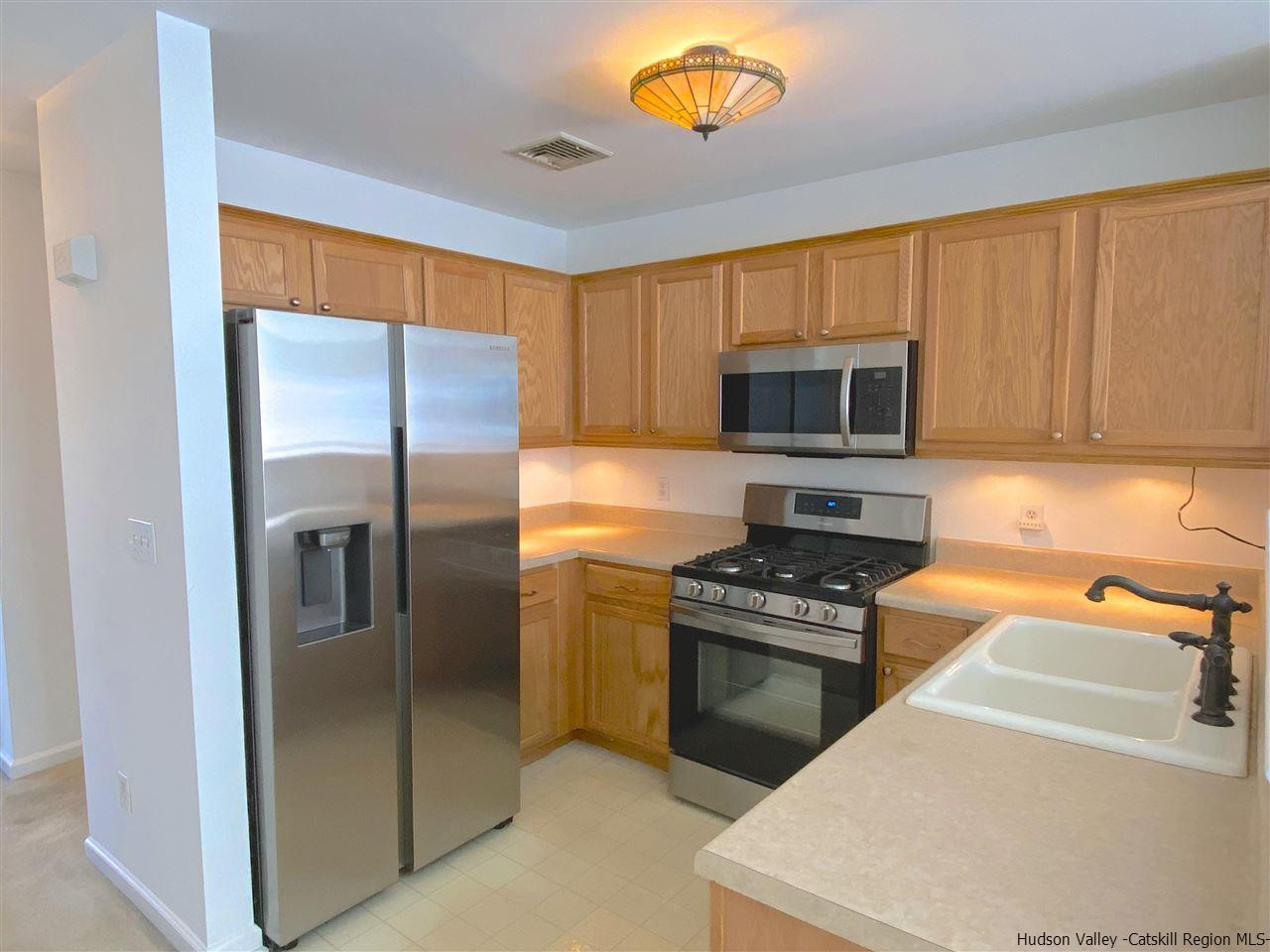 1036 Maggie Road, Unit 148 Newburgh, NY 12550 - Photo 4 of 19 a kitchen with a refrigerator stove and microwave