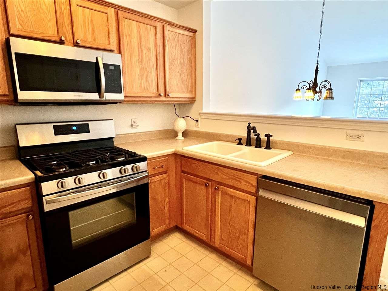 1036 Maggie Road, Unit 148 Newburgh, NY 12550 - Photo 5 of 19 a kitchen with stainless steel appliances a stove microwave and sink