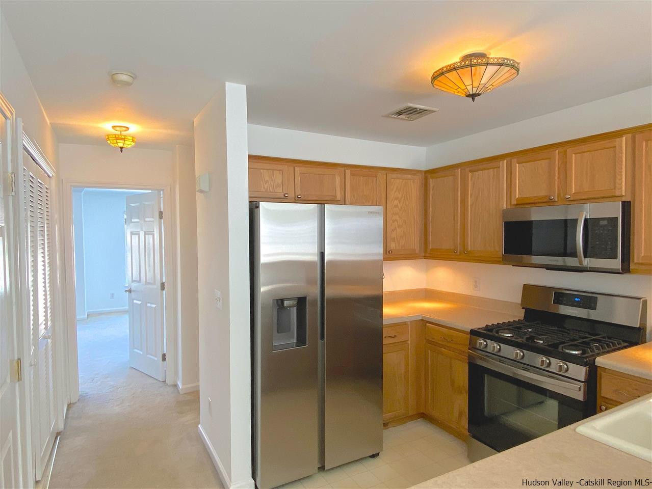 1036 Maggie Road, Unit 148 Newburgh, NY 12550 - Photo 6 of 19 a kitchen with stainless steel appliances granite countertop a refrigerator and a stove