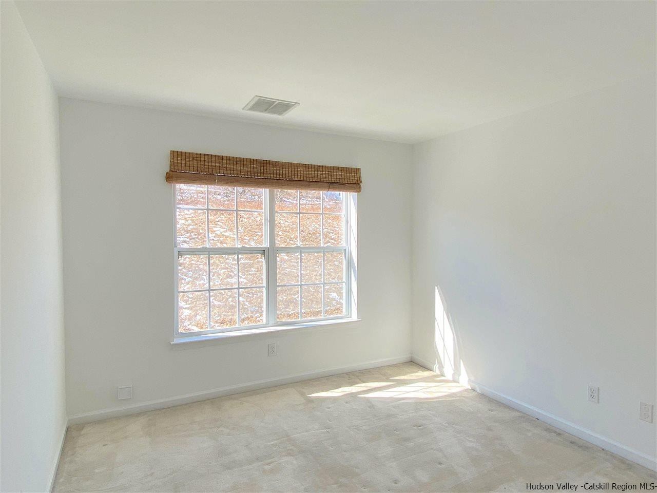 1036 Maggie Road, Unit 148 Newburgh, NY 12550 - Photo 10 of 19 an empty room with a window