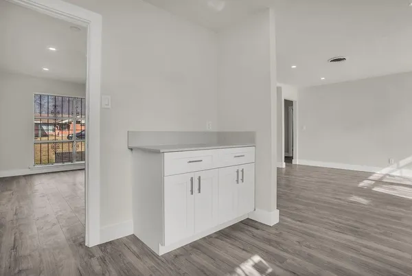 a view of a kitchen with wooden floor