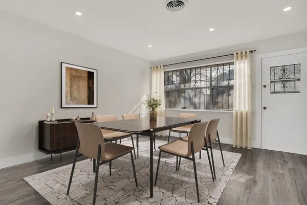 a view of a dining room with furniture and wooden floor