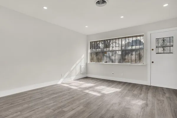 wooden floor in an empty room with a window