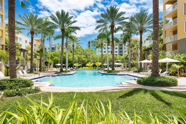 a view of swimming pool with palm trees