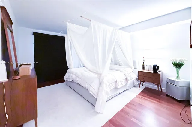 a bedroom with a bed and a chair