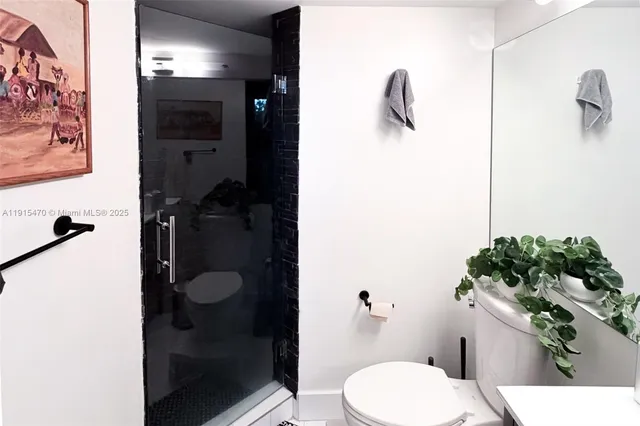 a bathroom with a toilet and a shower