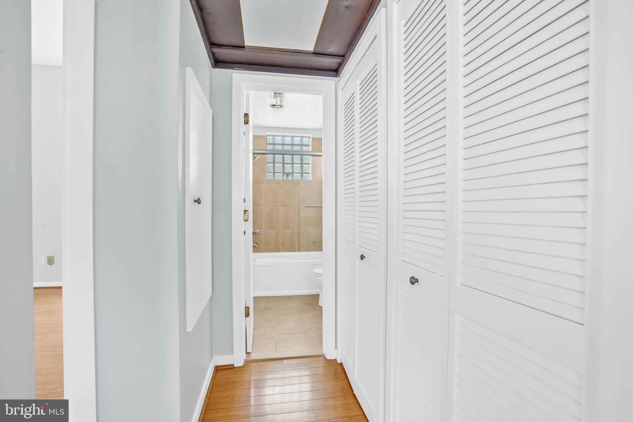 2114 N Street Northwest, Unit 46 Washington, DC 20037 - Photo 21 of 26 a view of a hallway with wooden floor and staircase