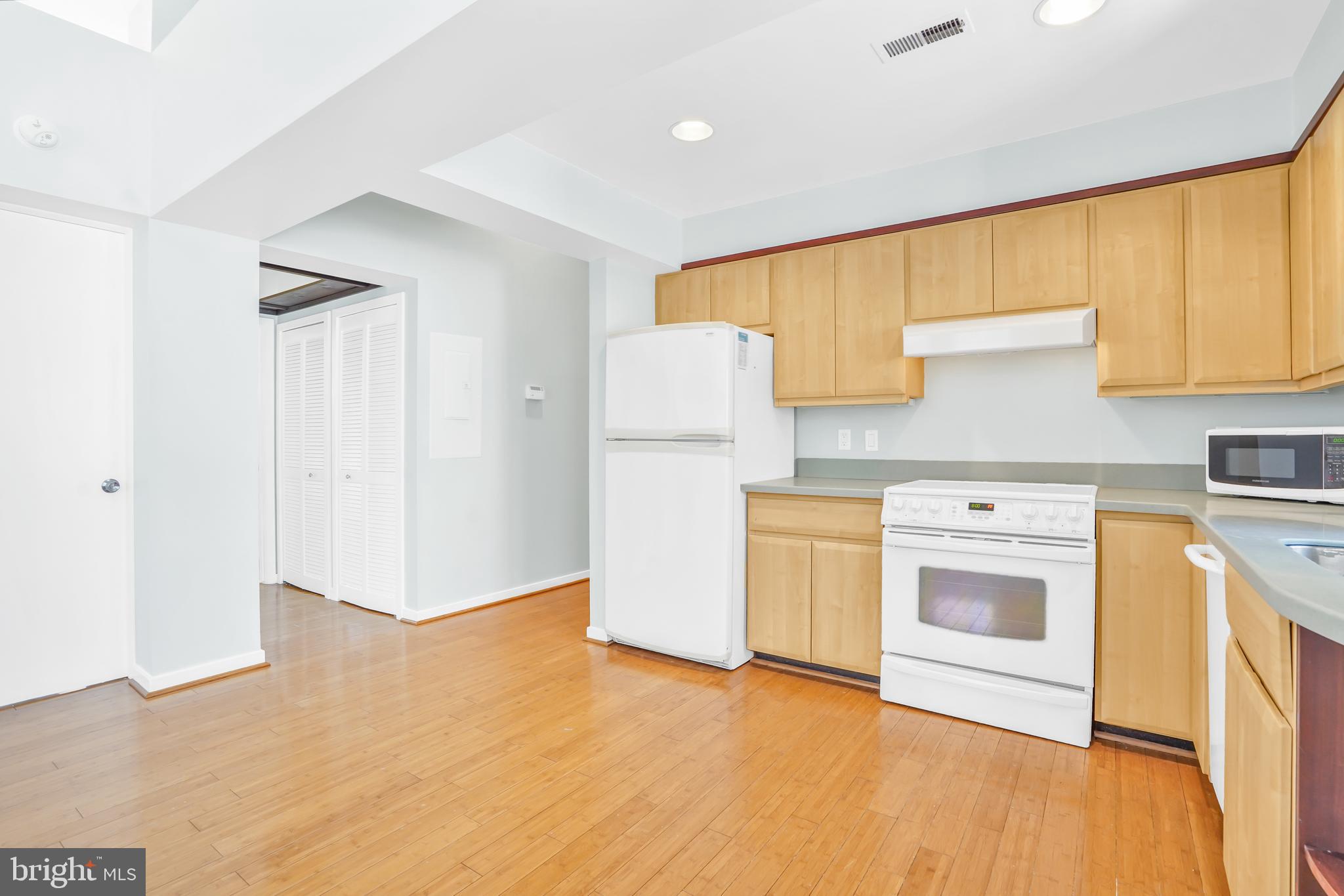 2114 N Street Northwest, Unit 46 Washington, DC 20037 - Photo 6 of 26 a kitchen with a stove a sink and a refrigerator