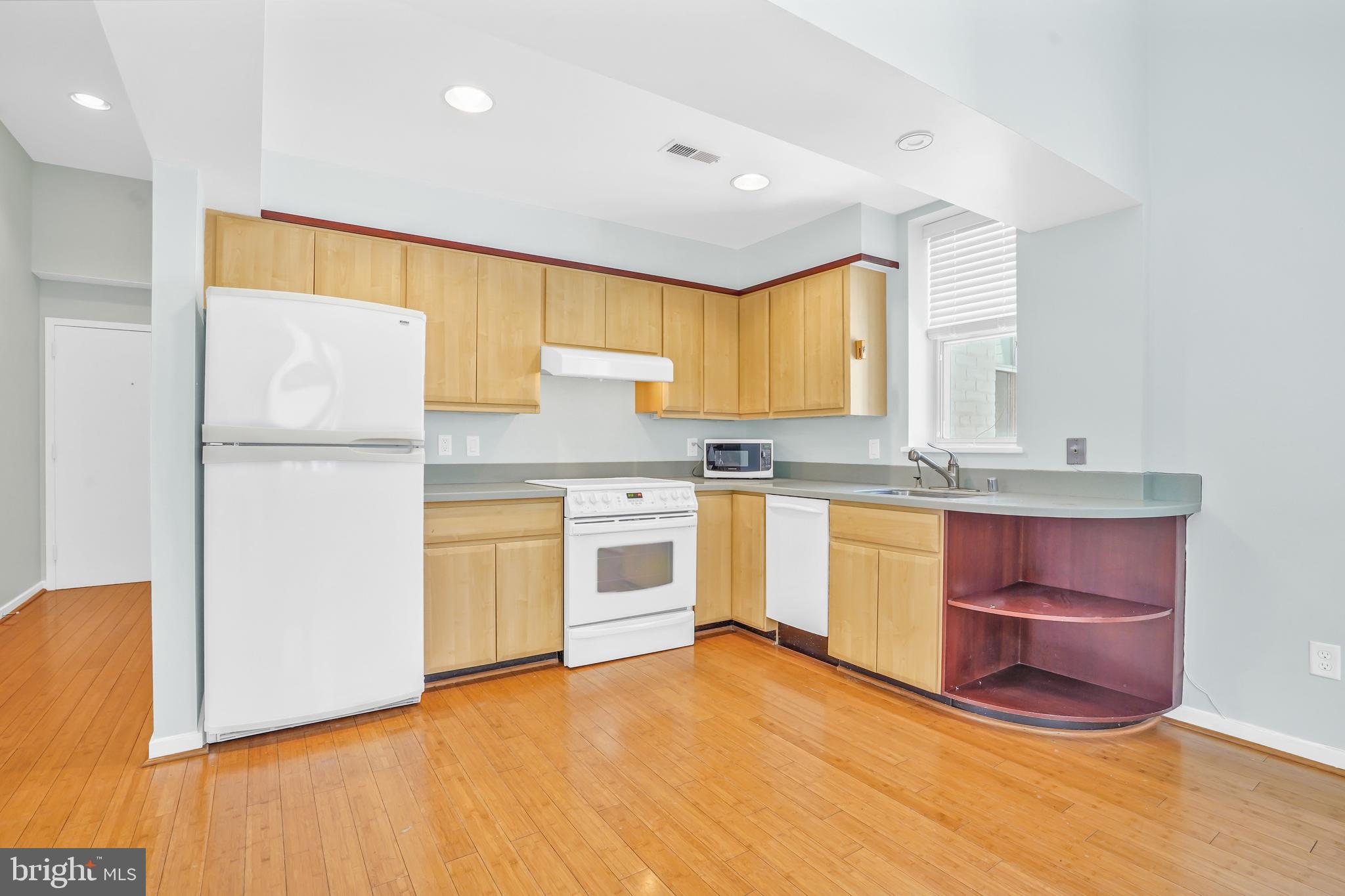 2114 N Street Northwest, Unit 46 Washington, DC 20037 - Photo 7 of 26 a kitchen with a sink window and stainless steel appliances