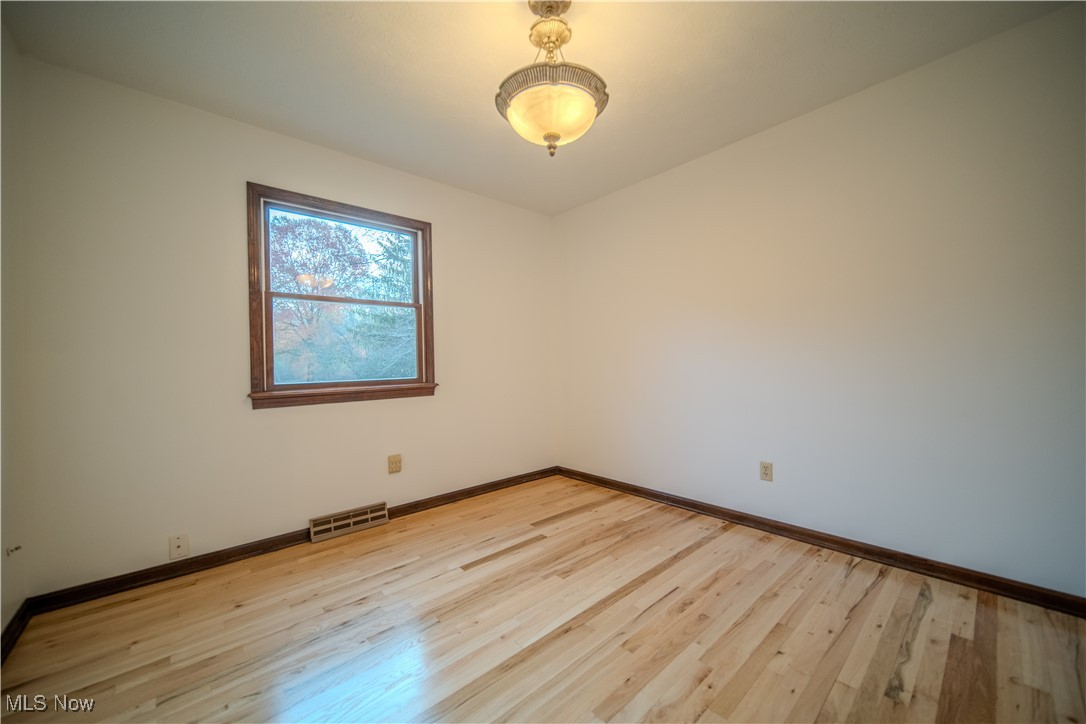 698 Albert Horning Road Atwater, OH 44201 - Photo 34 of 40 Spare room with light wood-style flooring and baseboards
