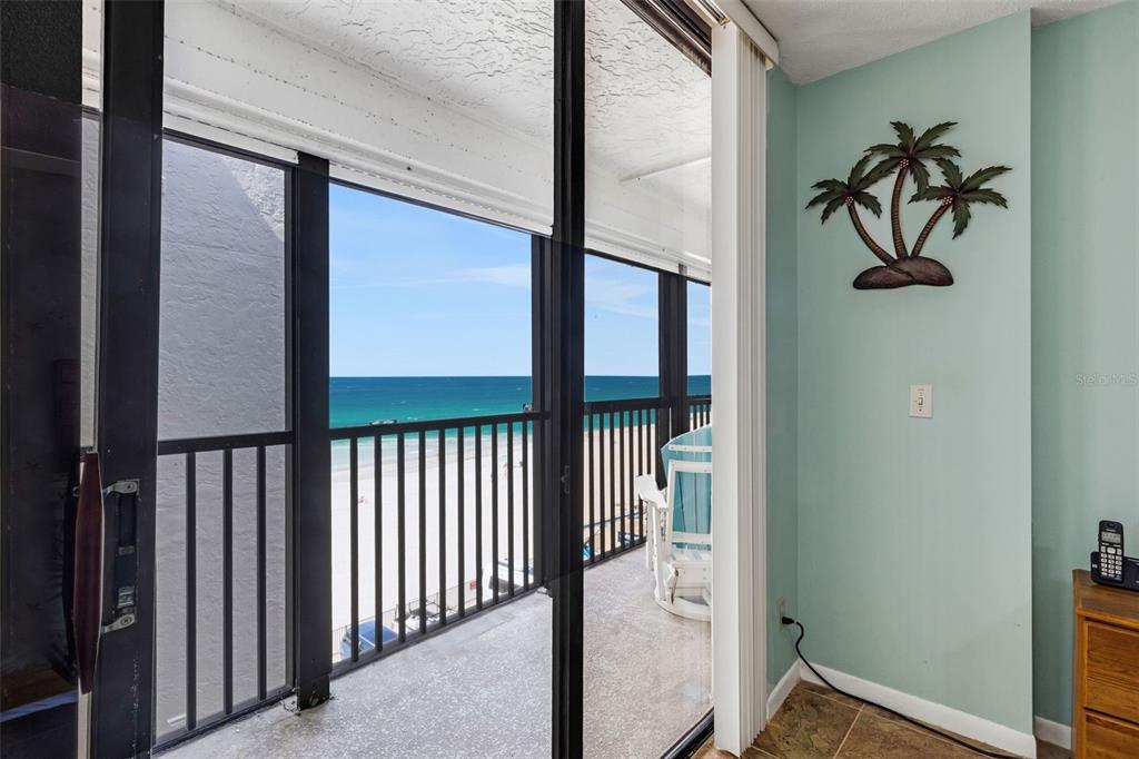 14900 Gulf Boulevard, Unit 410 Madeira Beach, FL 33708 - Photo 22 of 76 a view of a hallway with wooden floor and a glass door