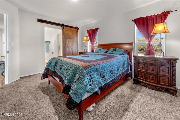 a bedroom with a bed and dresser with mirror