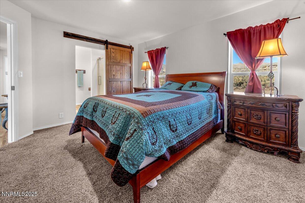 195 Muletail Circle Reno, NV 89508 - Photo 15 of 44 a bedroom with a bed and dresser with mirror