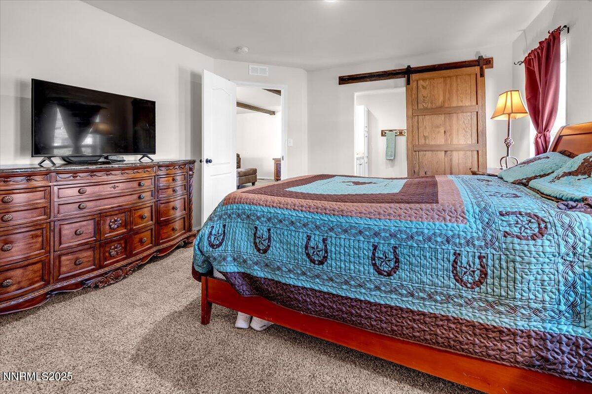 195 Muletail Circle Reno, NV 89508 - Photo 16 of 44 a bedroom with a bed and a flat screen tv