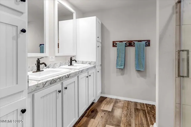 a bathroom with a sink a mirror and shower