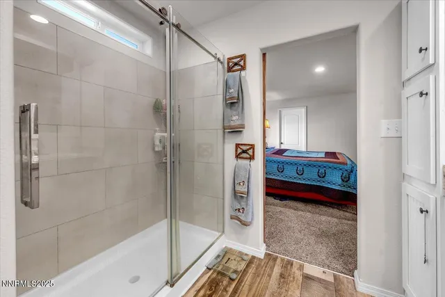 a bathroom with a tub shower and sink