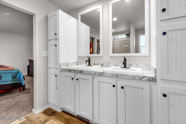 a bathroom with a granite countertop sink and a mirror