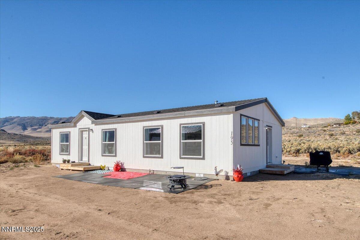 195 Muletail Circle Reno, NV 89508 - Photo 29 of 44 a backyard of a house with fire pit and outdoor seating