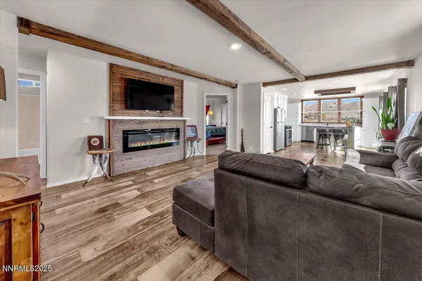 a living room with fireplace furniture and a flat screen tv
