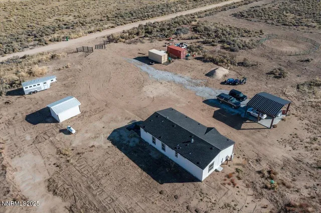 an aerial view of a house with a yard