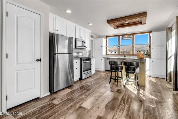 a kitchen with stainless steel appliances a refrigerator and a stove top oven