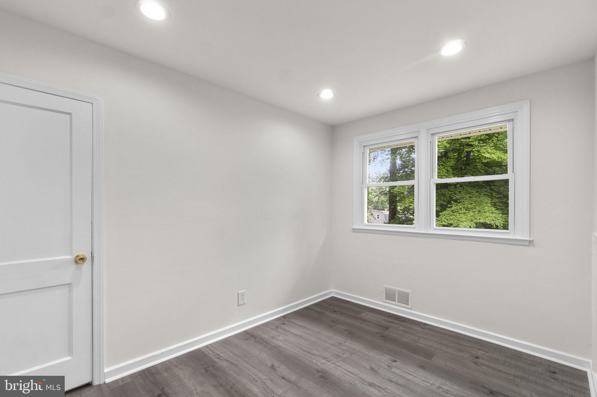 3658 Clifmar Road Baltimore, MD 21244 - Photo 28 of 43 an empty room with wooden floor and windows