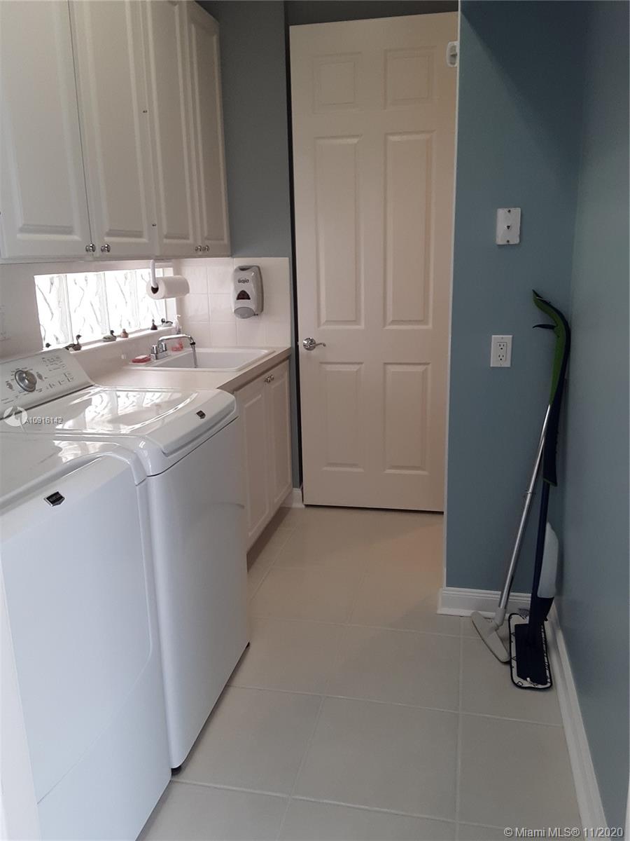 10889 Southwest Candlewood Road Port St. Lucie, FL 34987 - Photo 8 of 13 Laundry Room w/ MayTag Washer & Dryer