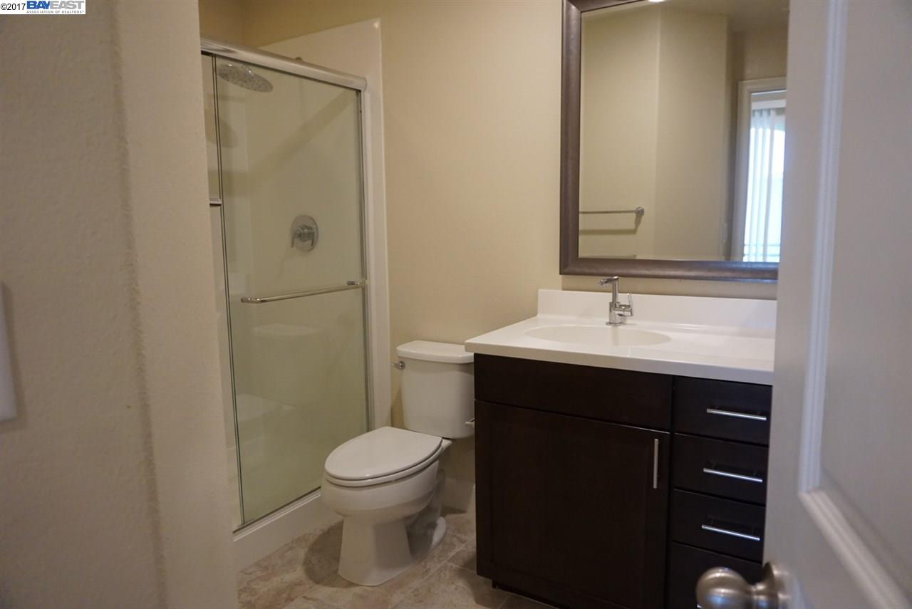 4728 Norris Canyon Road, Unit 205 San Ramon, CA 94583 - Photo 16 of 18 a bathroom with a sink a toilet and shower