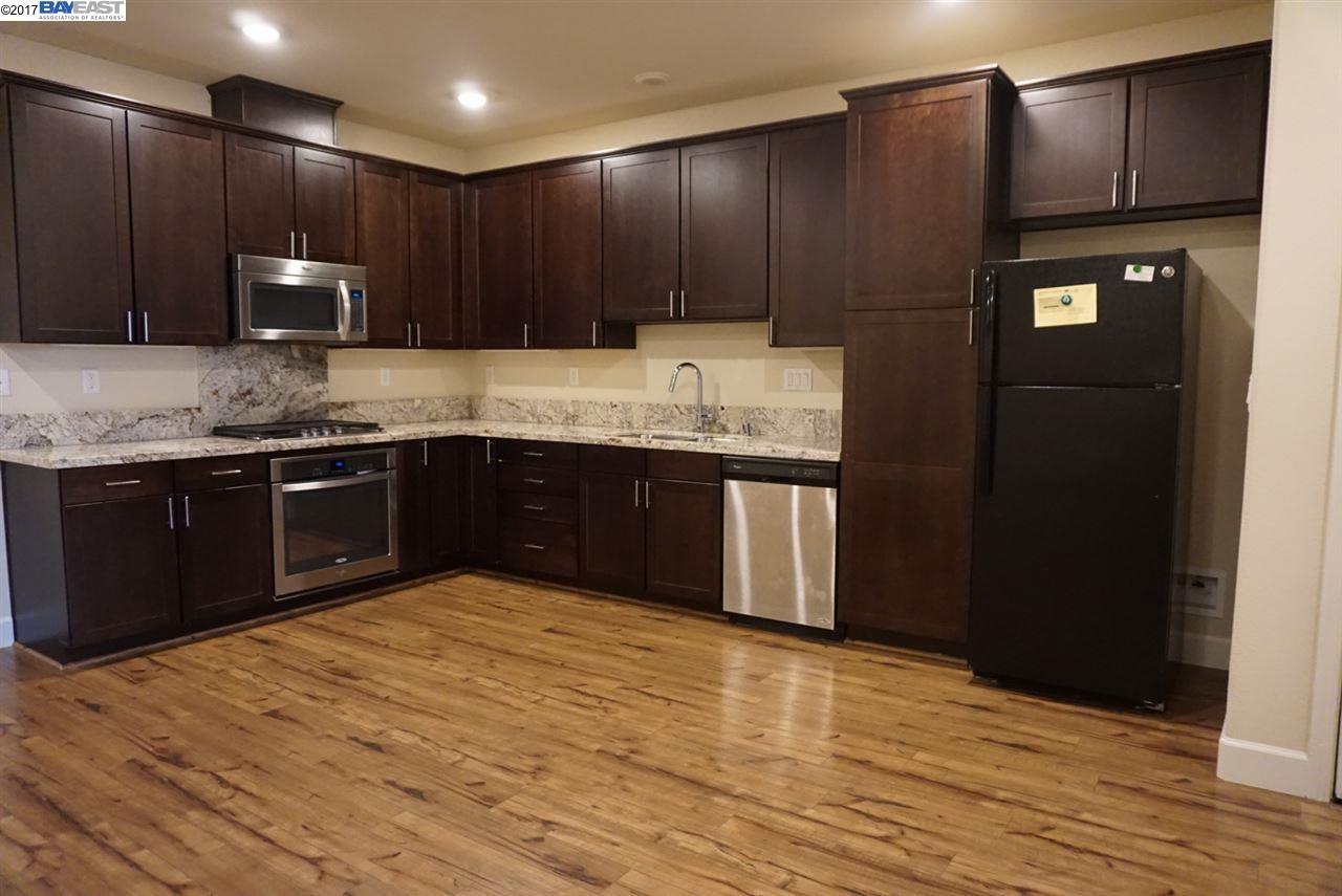 4728 Norris Canyon Road, Unit 205 San Ramon, CA 94583 - Photo 4 of 18 a kitchen with stainless steel appliances granite countertop wooden cabinets a refrigerator and a sink