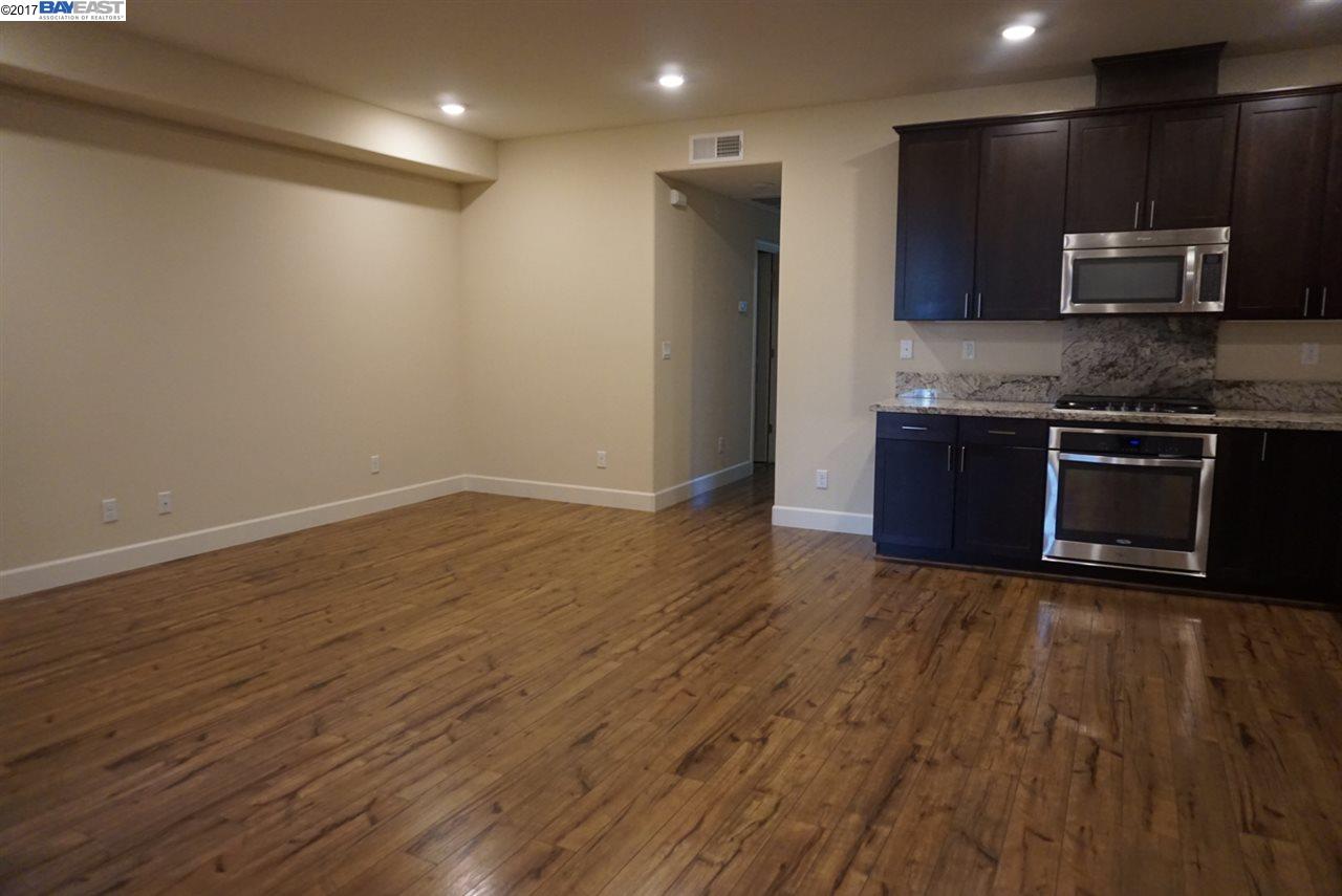 4728 Norris Canyon Road, Unit 205 San Ramon, CA 94583 - Photo 5 of 18 an empty room with kitchen appliances and wooden floor